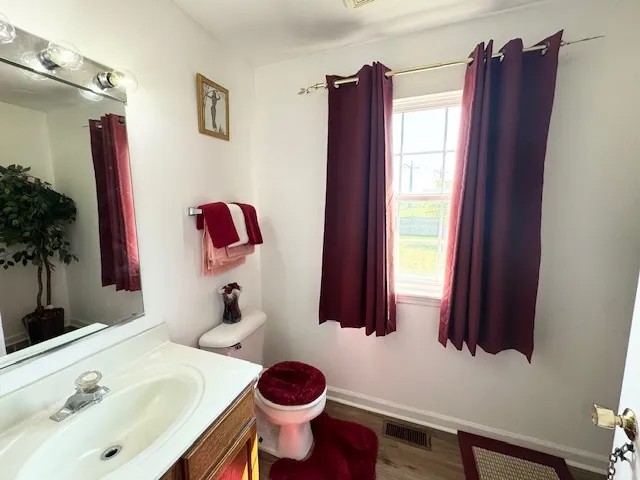 a bathroom with a sink toilet and a mirror