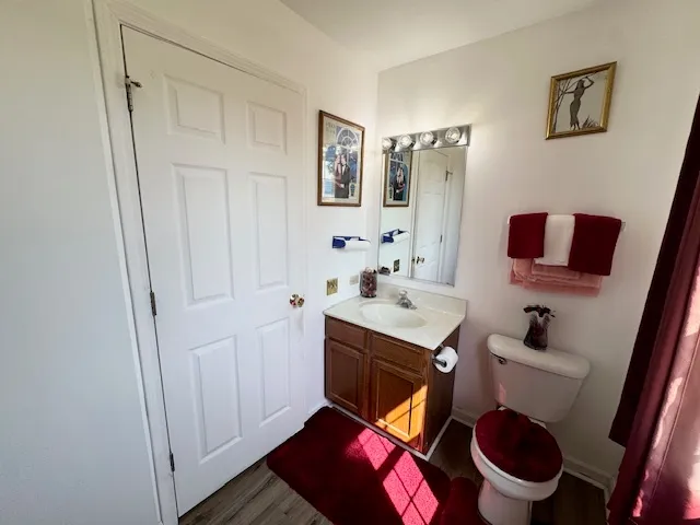 a bathroom with a toilet sink and mirror