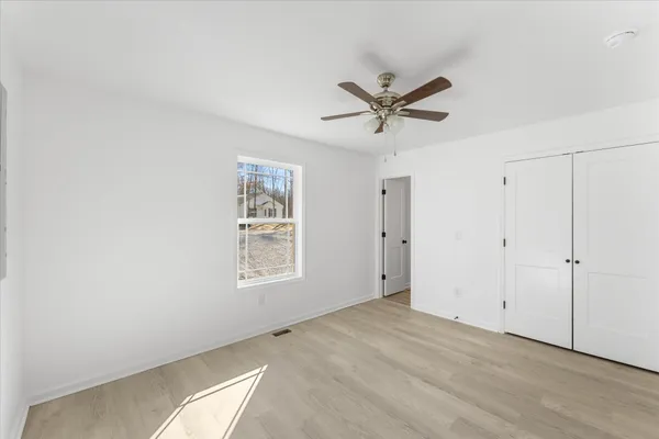 a view of a livingroom with a ceiling fan and window