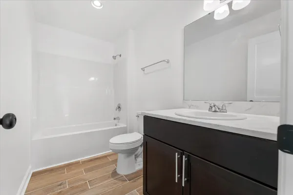 a bathroom with a sink toilet a mirror and shower