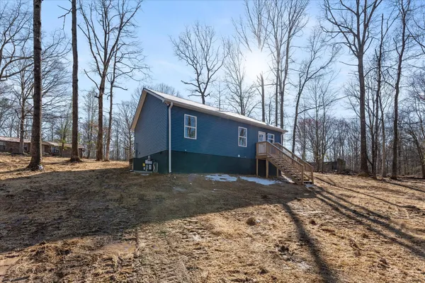 a view of a house with a yard covered in snow