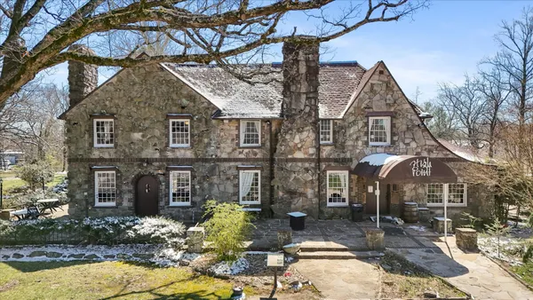 a front view of a house with a yard balcony