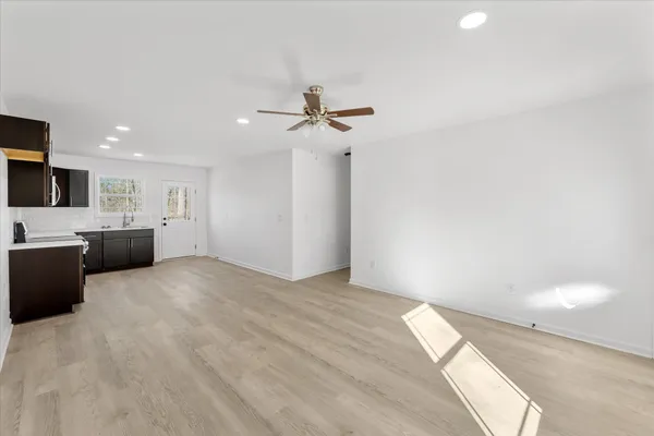a view of an empty room with a kitchen