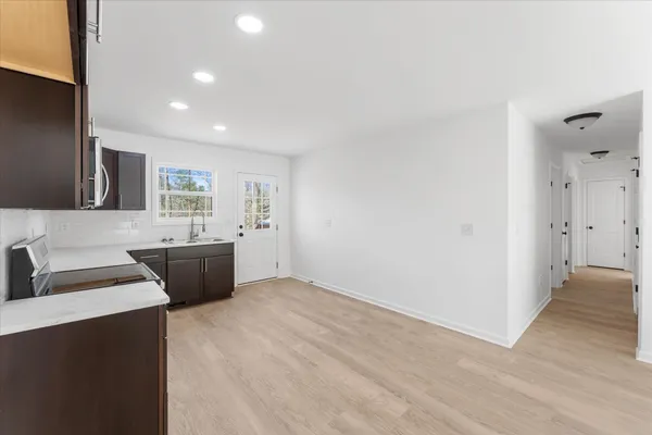a view of a kitchen with a sink and a refrigerator