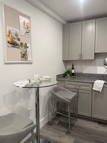 a kitchen with a refrigerator stove and white cabinets