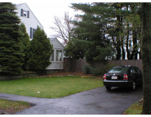 22 Bemis Road Newton, MA 02460 - Photo 14 of 14 a car parked in front of a house and a yard