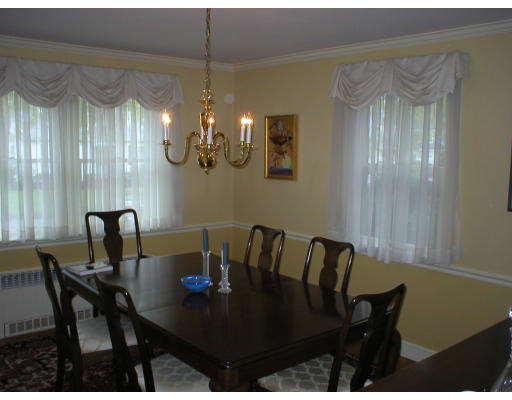 22 Bemis Road Newton, MA 02460 - Photo 6 of 14 a view of a dining room with furniture and chandelier