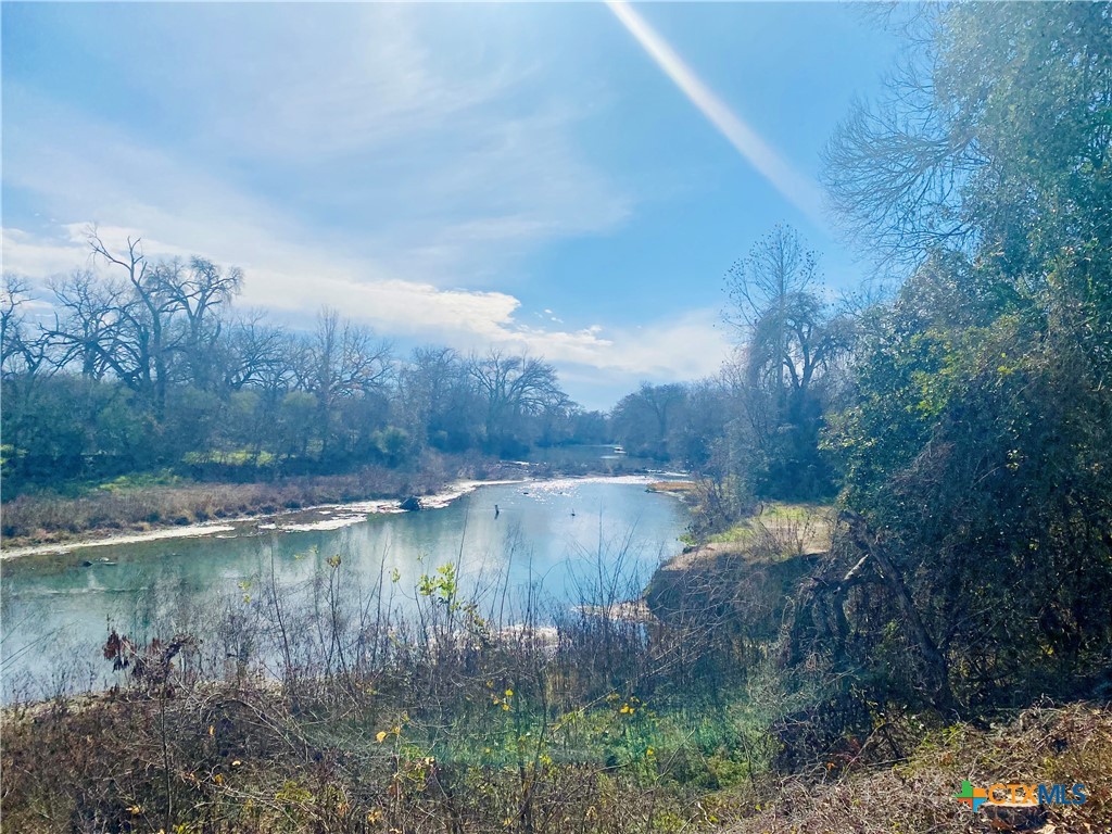 a view of a water pond with green space