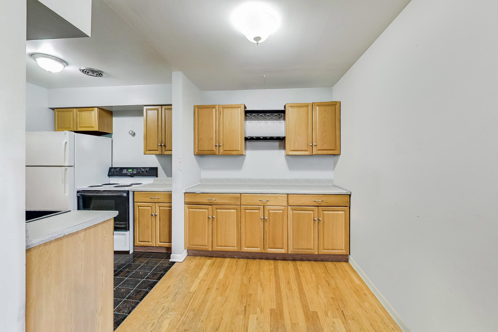 7120 North Sheridan Road, Unit 516 Chicago, IL 60626 - Photo 5 of 6 a kitchen with stainless steel appliances granite countertop a stove a sink and a refrigerator