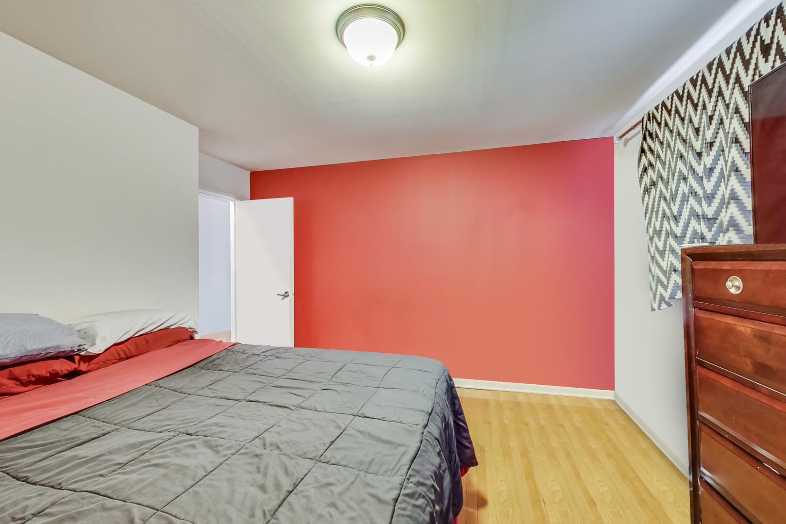 7120 North Sheridan Road, Unit 516 Chicago, IL 60626 - Photo 6 of 6 a bedroom with a bed and a mirror