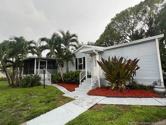 a front view of a house with a yard and porch