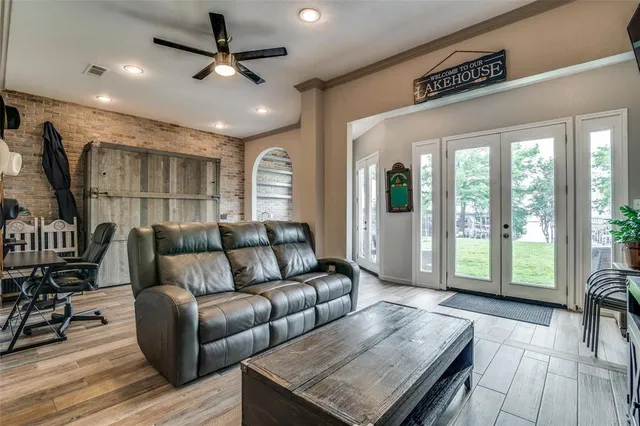 a living room with furniture and a floor to ceiling window