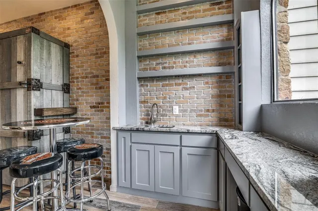 a kitchen with granite countertop a sink and a stove