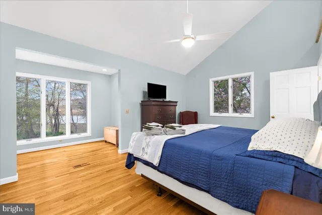 a bedroom with a large bed and a window