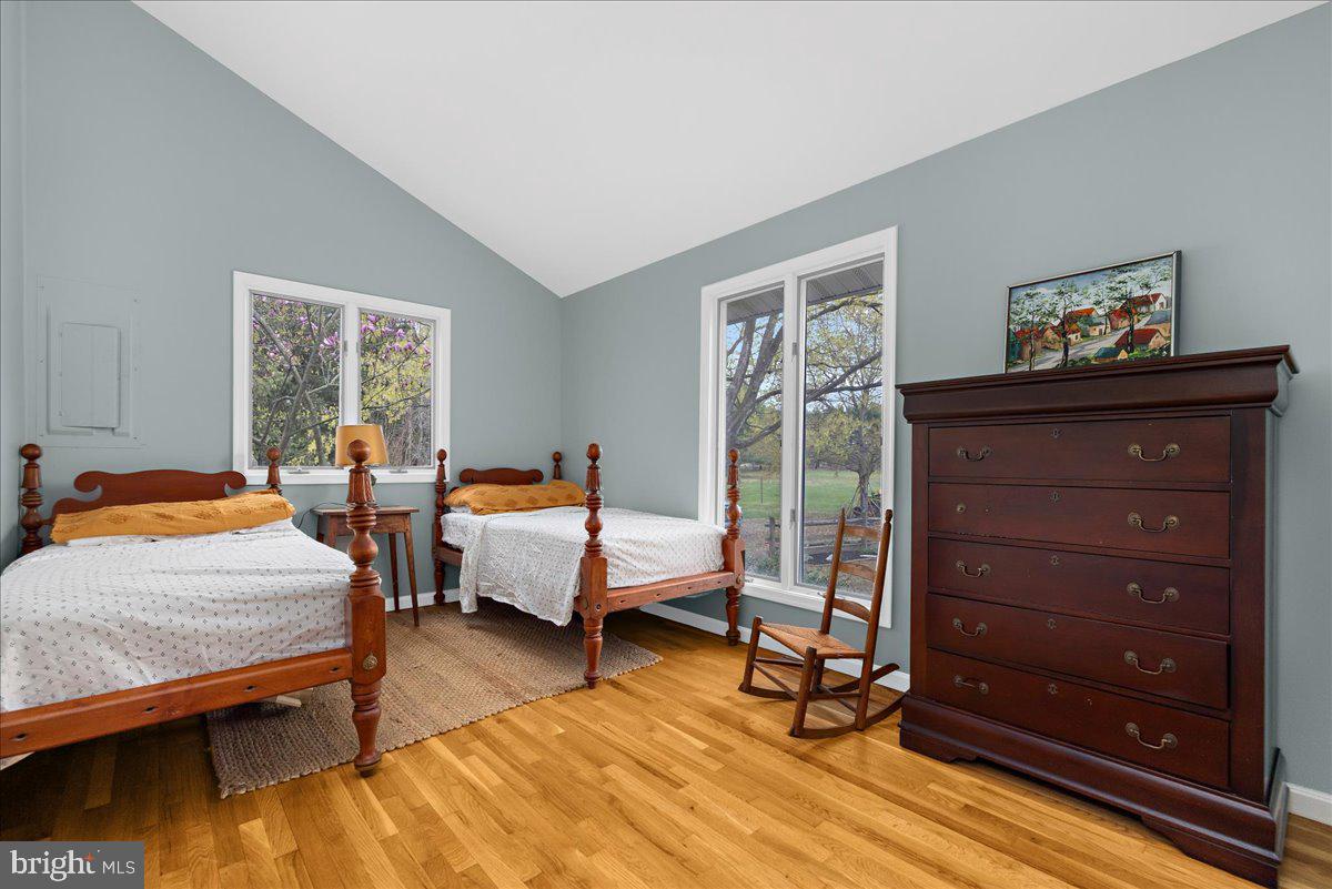 26889 Morgnec Road Chestertown, MD 21620 - Photo 18 of 32 a bedroom with a bed and wooden floor