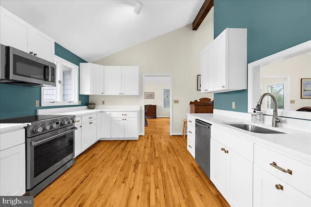 a kitchen with wooden floors and white appliances