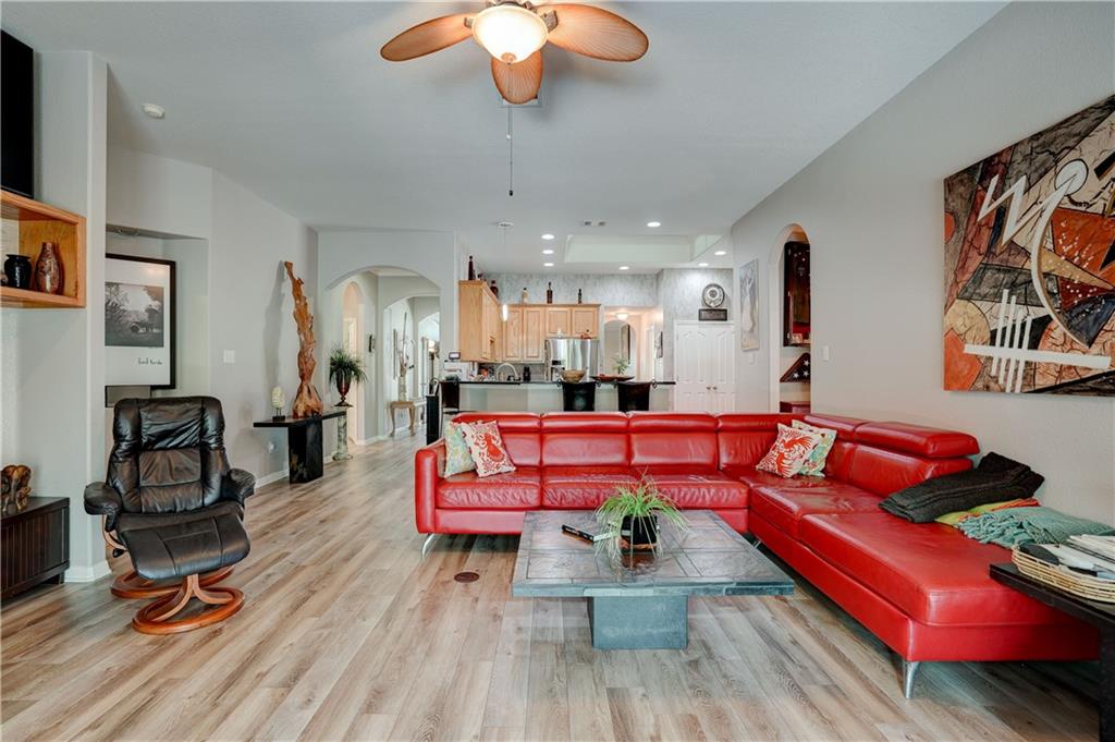 2513 Wanakah Ridge Drive Cedar Park, TX 78613 - Photo 15 of 34 a living room with furniture a wooden floor and a chandelier