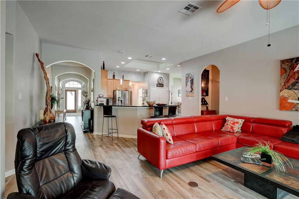 2513 Wanakah Ridge Drive Cedar Park, TX 78613 - Photo 16 of 34 a living room with furniture a rug and a chandelier