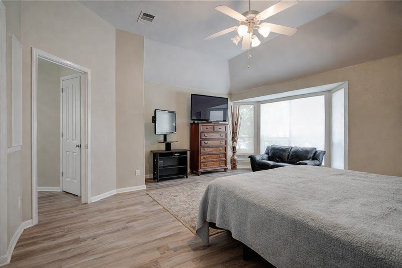 2513 Wanakah Ridge Drive Cedar Park, TX 78613 - Photo 22 of 34 a large bedroom with a bed and a chandelier