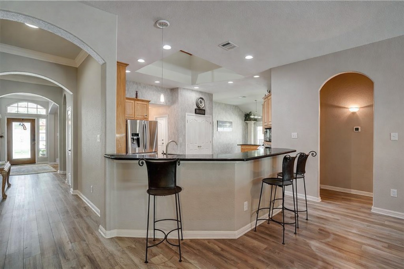 2513 Wanakah Ridge Drive Cedar Park, TX 78613 - Photo 7 of 34 a kitchen with stainless steel appliances granite countertop a table chairs stove and wooden floor