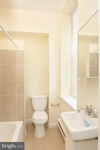 a bathroom with a toilet a sink and a shower