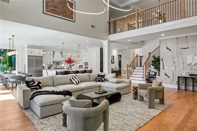 a hallway with wooden floor and staircase