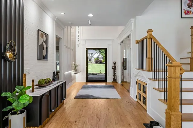 a room with lots of wooden furniture and a glass door shower