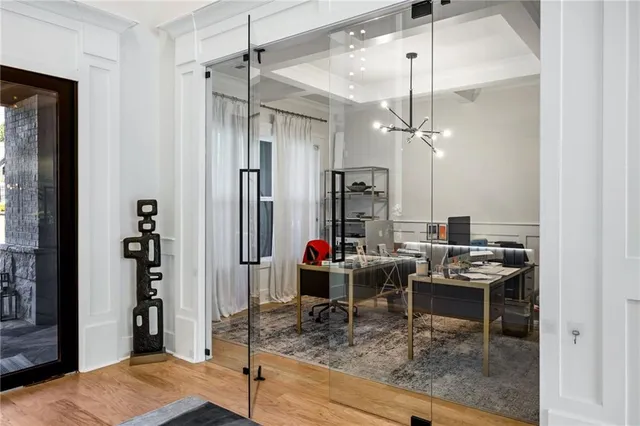 a bedroom with a large bed and a chandelier