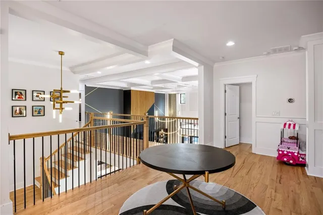 a living room with furniture a fireplace and a chandelier