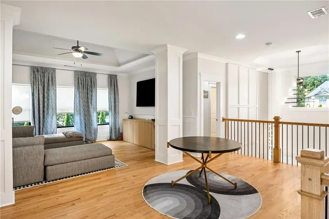 a spacious bedroom with a bed and a chandelier