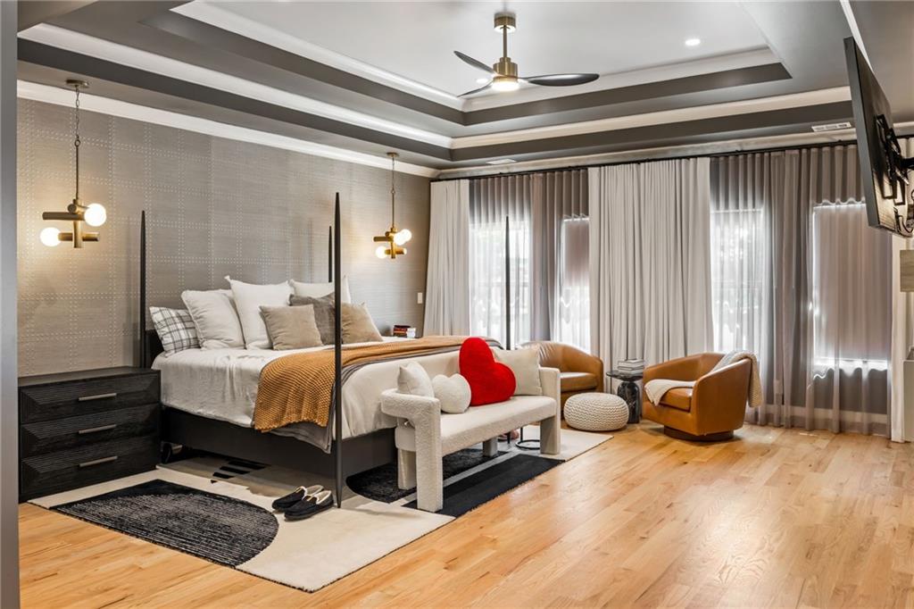 2641 Camp Branch Road Buford, GA 30519 - Photo 23 of 44 a spacious bedroom with a bed and a chandelier