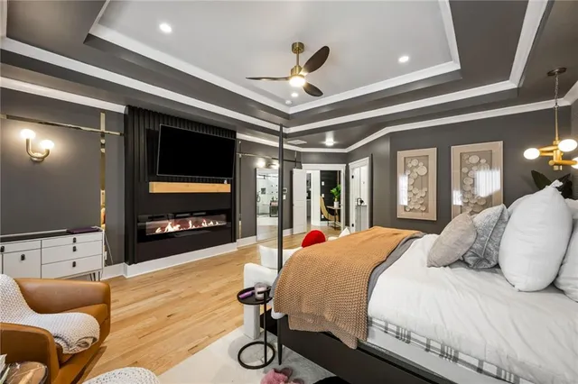 a view of a living room with furniture and wooden floor