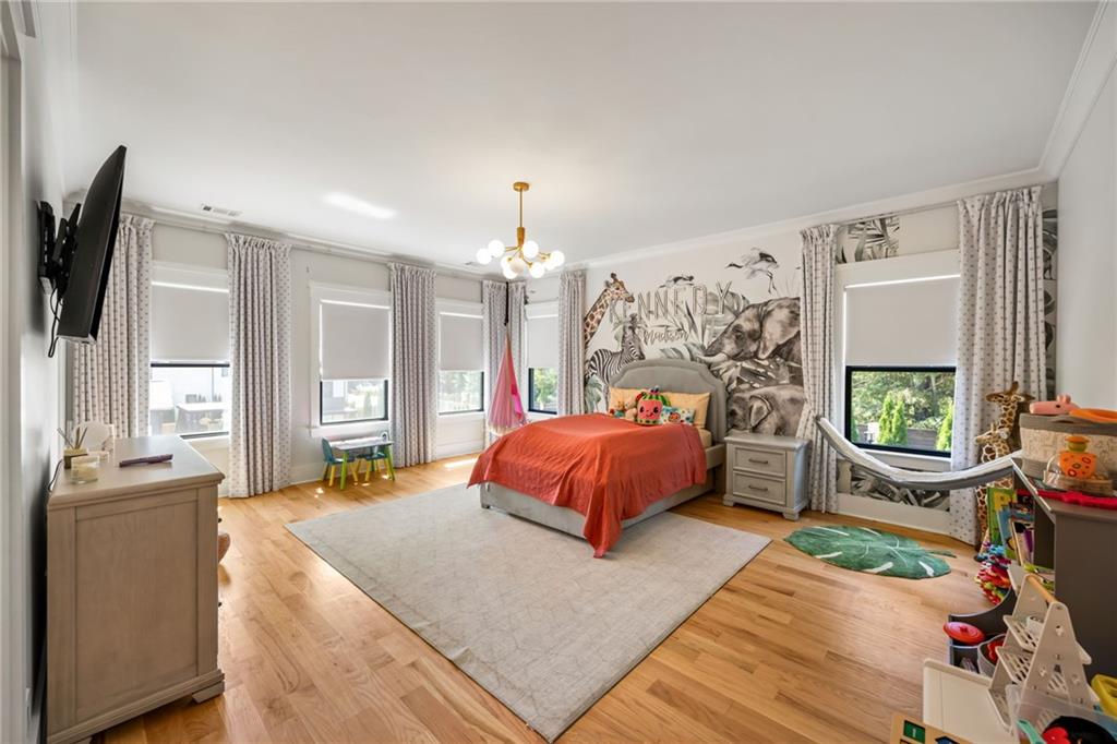 2641 Camp Branch Road Buford, GA 30519 - Photo 30 of 44 a spacious bedroom with a bed a flat screen tv and dresser