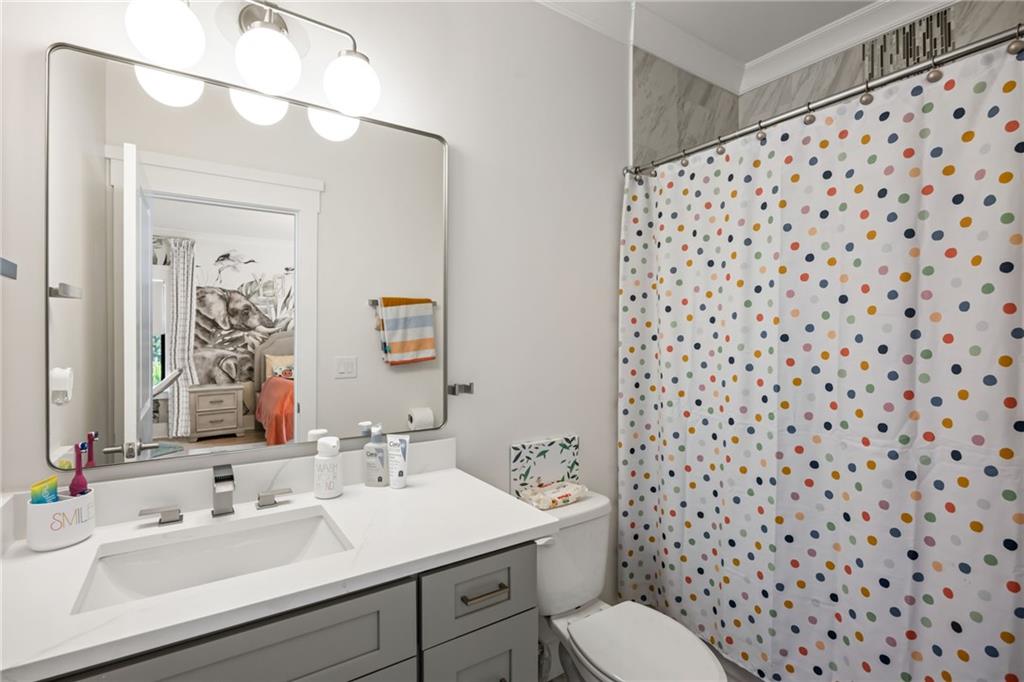 2641 Camp Branch Road Buford, GA 30519 - Photo 31 of 44 a bathroom with a sink and a mirror