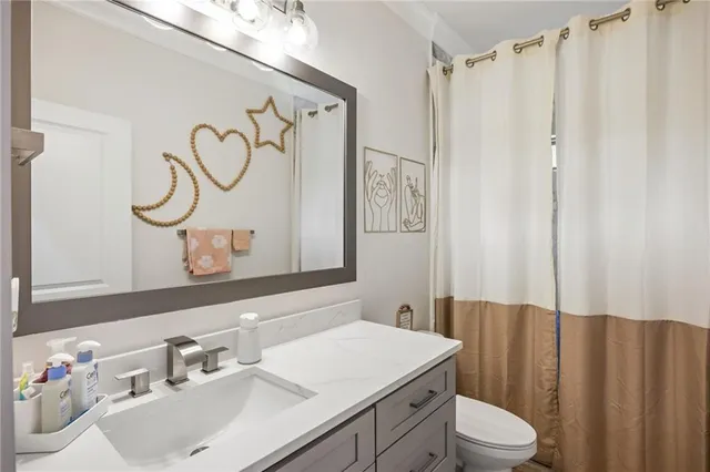 a kitchen with stainless steel appliances a sink a stove and cabinets