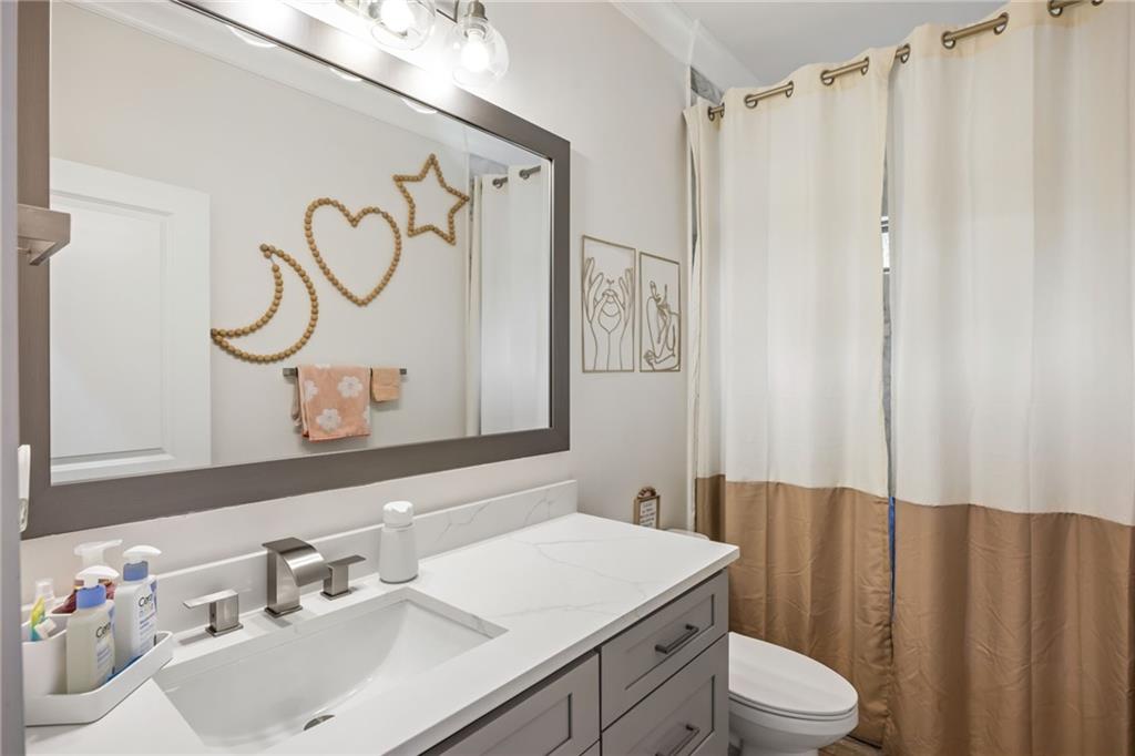 2641 Camp Branch Road Buford, GA 30519 - Photo 33 of 44 a bathroom with a sink vanity mirror and toilet