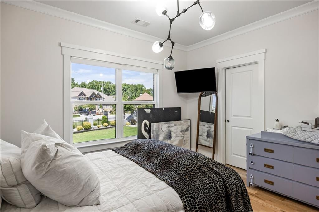 2641 Camp Branch Road Buford, GA 30519 - Photo 35 of 44 a bedroom with a bed window and a flat screen tv