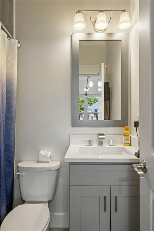 2641 Camp Branch Road Buford, GA 30519 - Photo 36 of 44 a bathroom with a toilet sink and mirror