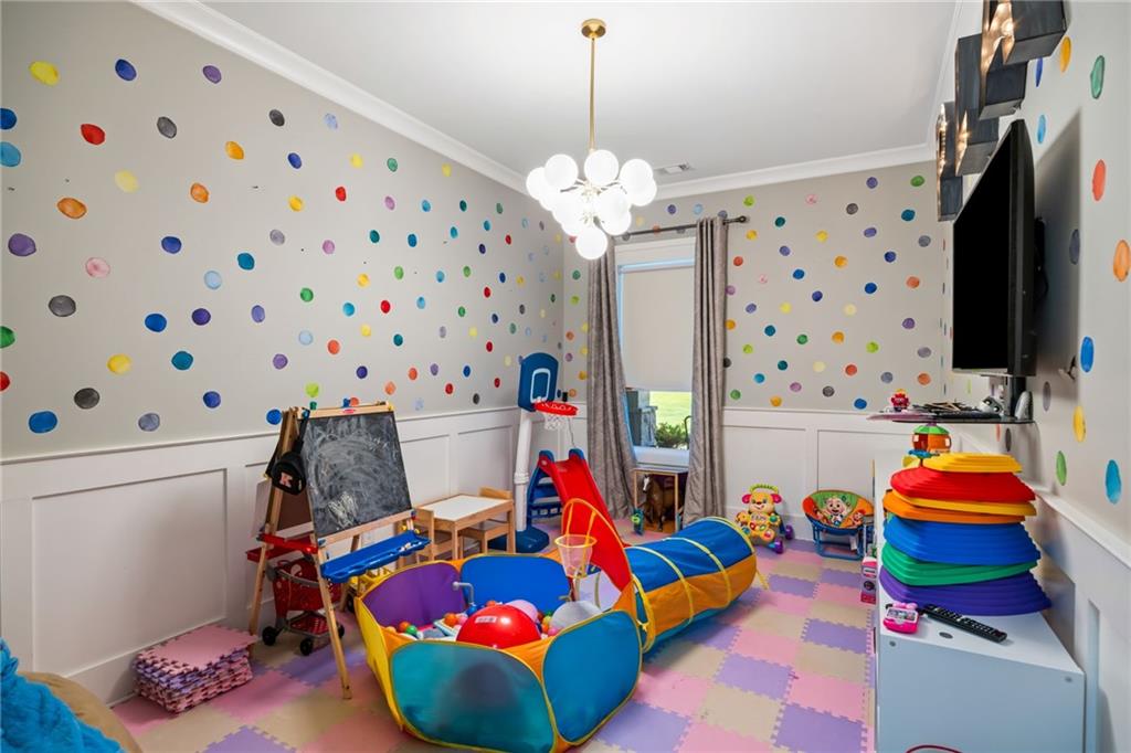 2641 Camp Branch Road Buford, GA 30519 - Photo 37 of 44 a living room filled with furniture and a flat screen tv