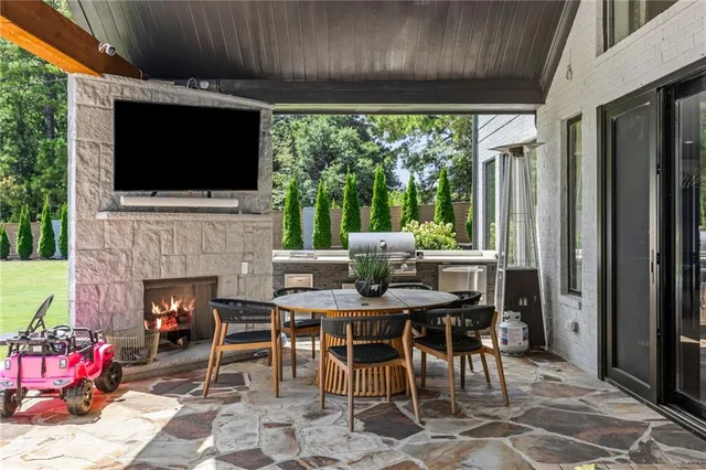 a view of a house with backyard patio and swimming pool