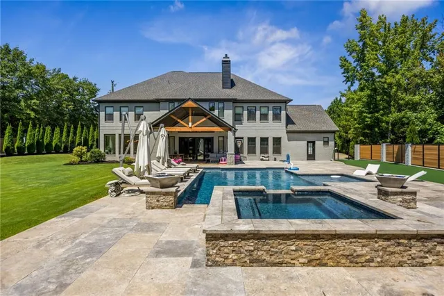 a living room with furniture pool table flat screen tv and a table