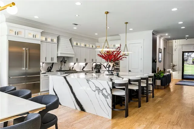 a kitchen with kitchen island granite countertop a sink stainless steel appliances and cabinets