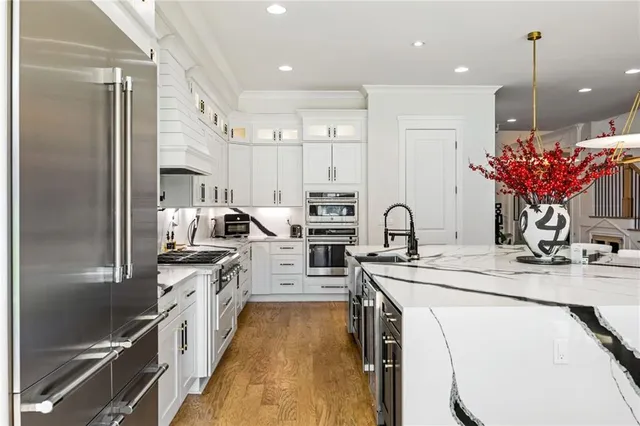 a kitchen with appliances cabinets and a table
