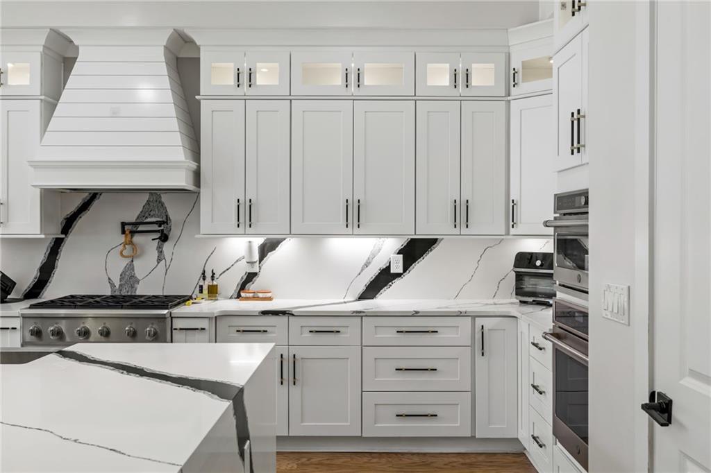 2641 Camp Branch Road Buford, GA 30519 - Photo 10 of 44 a kitchen with appliances cabinets and a table