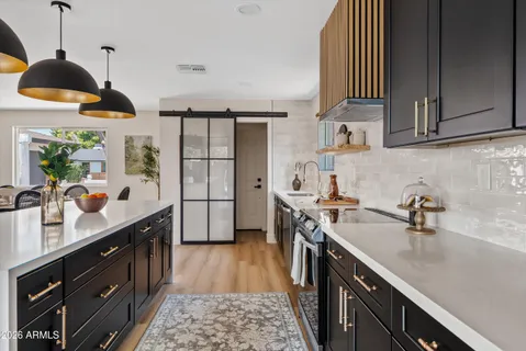 a kitchen with a sink a stove and cabinets