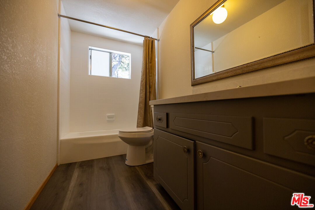 5212 Lone Pine Canyon Road Wrightwood, CA 92397 - Photo 15 of 42 a bathroom with a toilet and a bathtub