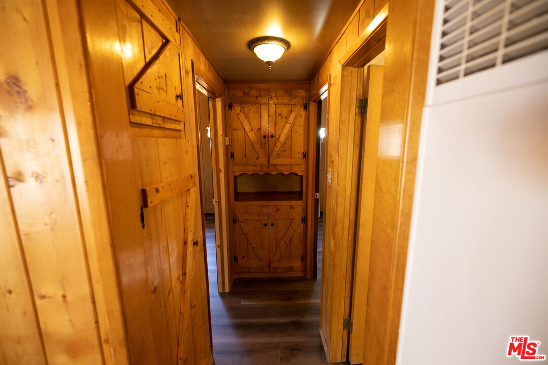 5212 Lone Pine Canyon Road Wrightwood, CA 92397 - Photo 16 of 42 a view of a hallway with wooden door