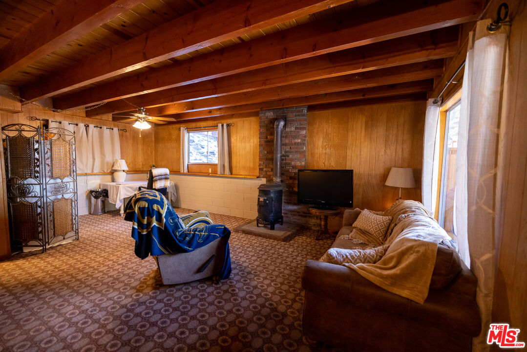 5212 Lone Pine Canyon Road Wrightwood, CA 92397 - Photo 18 of 42 a living room with furniture a couch and a window