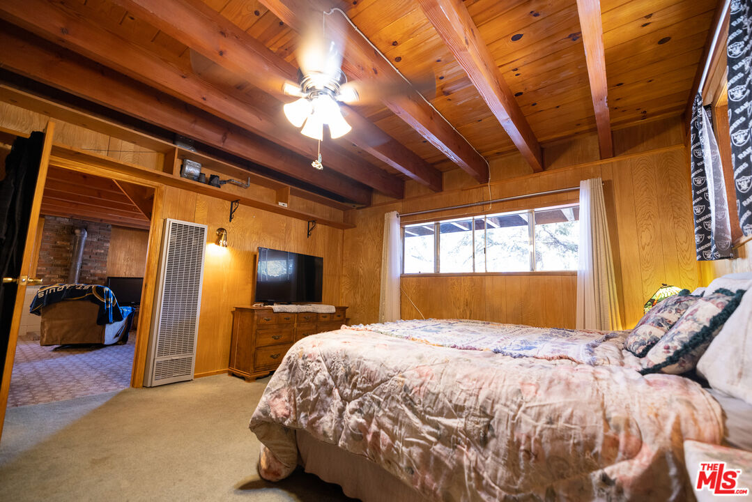 5212 Lone Pine Canyon Road Wrightwood, CA 92397 - Photo 27 of 42 a bed sitting in a bedroom next to a window