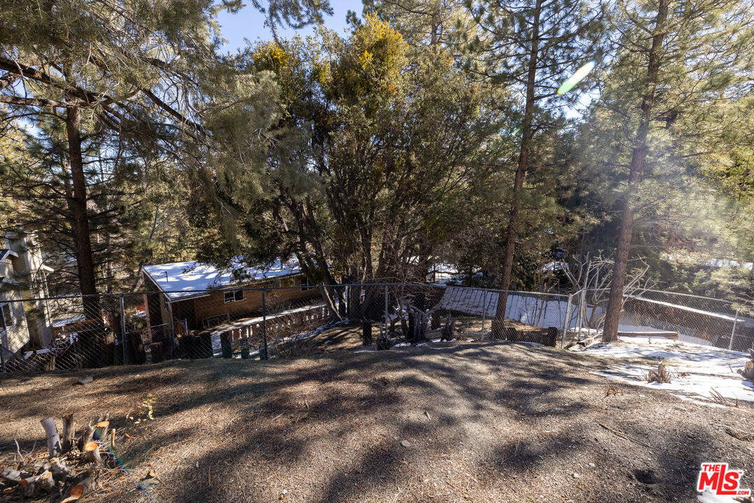 5212 Lone Pine Canyon Road Wrightwood, CA 92397 - Photo 30 of 42 a view of a bench in the middle of a yard